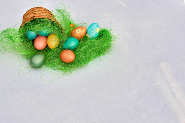 istock Easter basket filled with colorful eggs on a white background 653429774