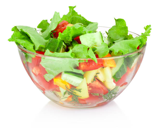 istock Fresh vegetable salad in glass bowl isolated on white background 653431990
