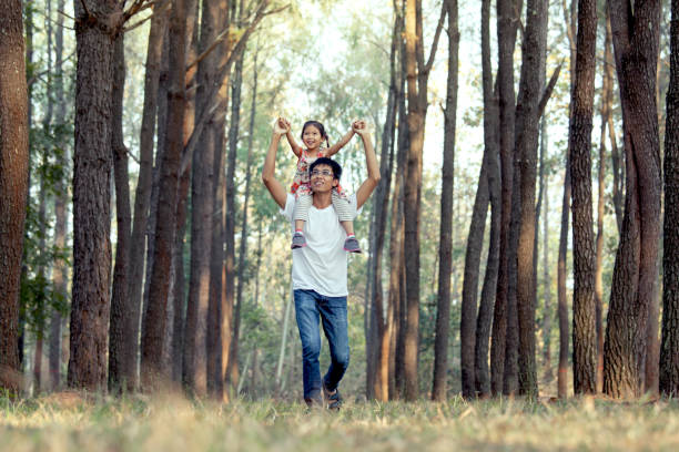 istock Father and daughter having fun and playing in the park 653435614