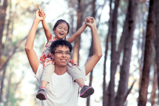 istock Father and daughter having fun and playing in the park 653437060