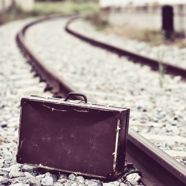 istock suitcase next to the railroad tracks 653437082