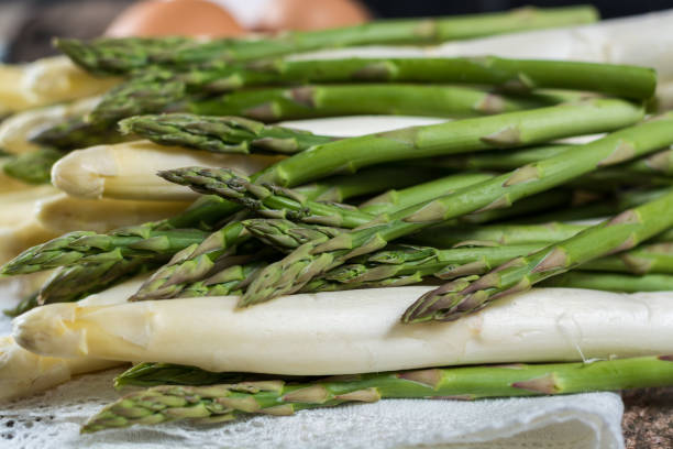 istock Spring season - fresh white and green uncooked asparagus 653439810