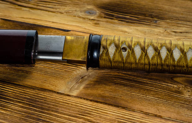 istock Japanese sword katana on wooden background 653440196