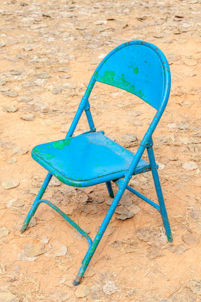 istock Old rusty blue chair leave alone in abandoned dried backyard. 653446968