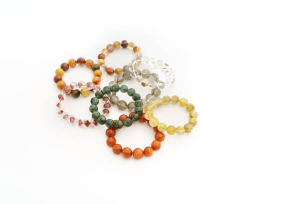 istock Beautiful translucent assorted colors Rutilated Quartz or Venus' hairstone bead in bracelets on white background 653447224