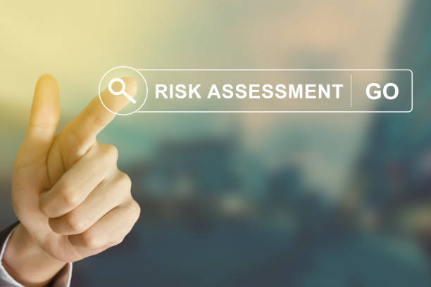 business hand clicking risk assessment button on search toolbar stock photo