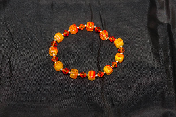 istock orange and yellow beaded bracelet 653447760