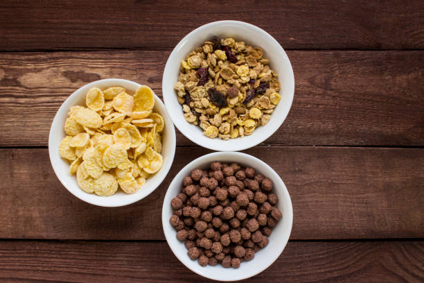istock Three bowls of cereals on wooden table 653449310