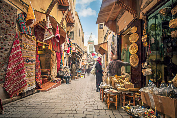 Streets of Fez Stores in the medina streets of Fez, Morocco. exoticism stock pictures, royalty-free photos & images