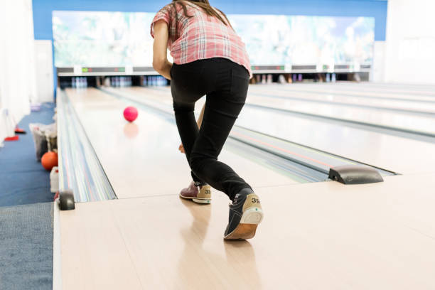 istock Good looking woman throwing her bowling ball 653453610
