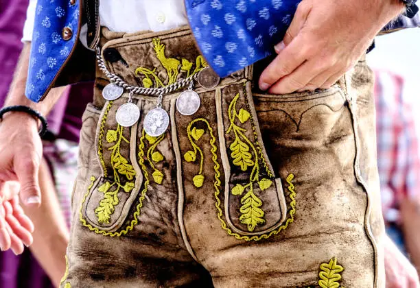 close-up of a typical bavarian "krachlederne" - traditional clothing with antique coins