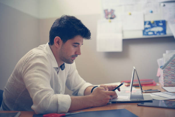 istock Businessman using phone in the office. 653459856