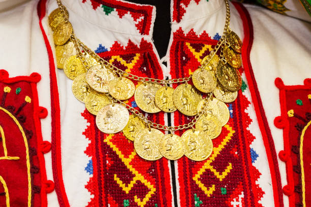 Women's blouse with colorful hand-embroidered embellished with a necklace of gold coins. Traditional crafts of Bulgaria, stock photo