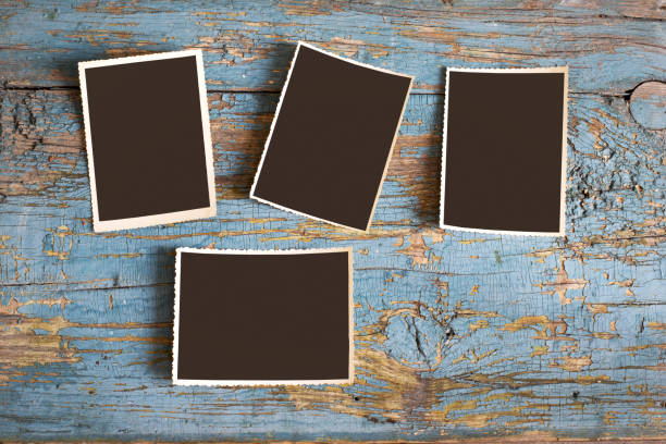 istock Set of old photos on a blue background, top view 653467274