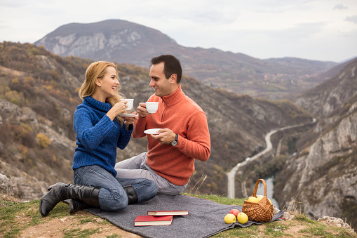 Couple enjoy in picnic with cup of coffee and tea