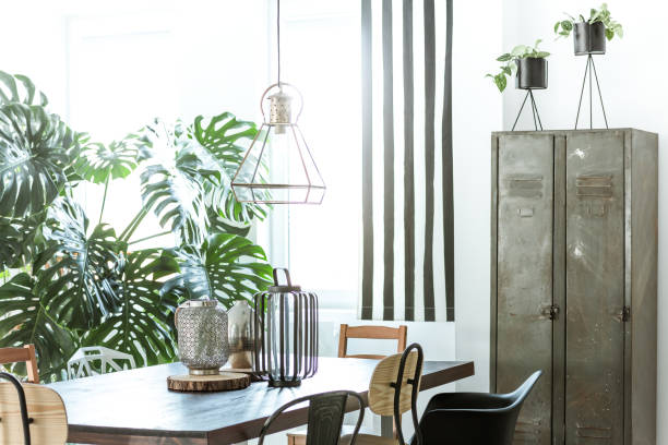 Industrial dining room with wardrobe White, industrial dining room with metal wardrobe and wood table bicycle light photos stock pictures, royalty-free photos & images