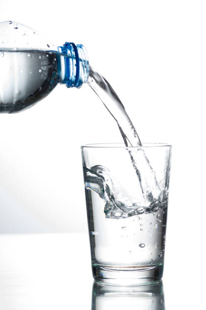 istock Pouring water from bottle into glass 653486094