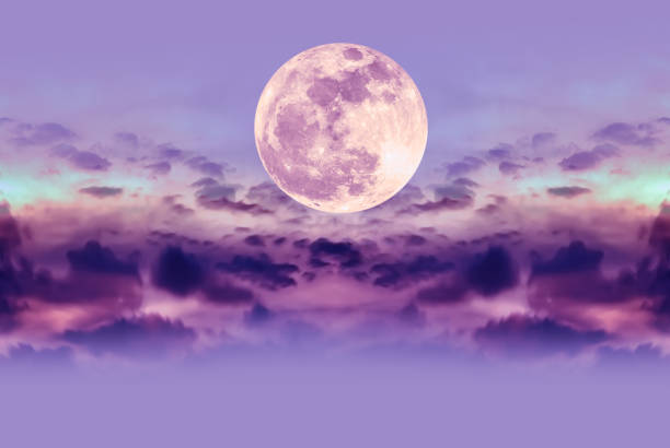 Nighttime sky with clouds and bright full moon with shiny. stock photo