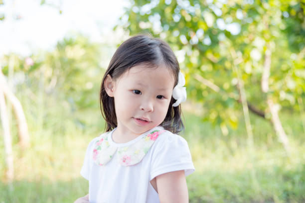 istock girl with flower in garden 653487626