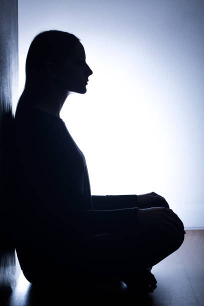 istock Girl sitting back to wall 653490596