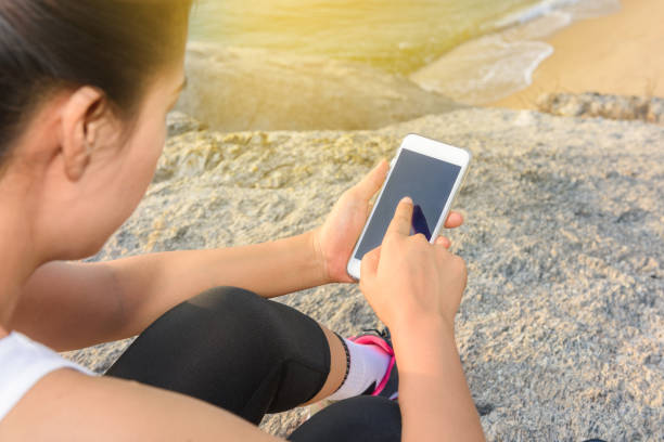 istock Young sport woman using smartphone 653490858
