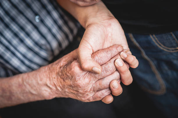 istock Assistant In The Community Center Helping A Senior Men 653495134