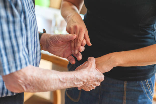istock Assistant In The Community Center Helping A Senior Men 653495202