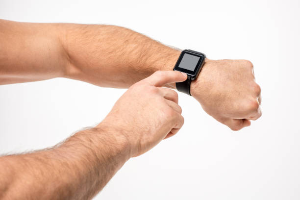 istock football player in uniform pointing on smartwatch 653497800