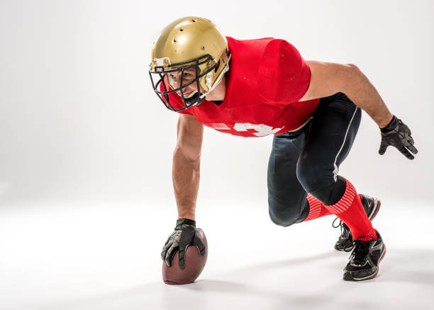 istock football player holding ball 653497950