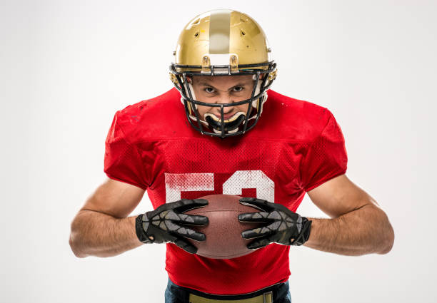 istock football player holding ball 653497996