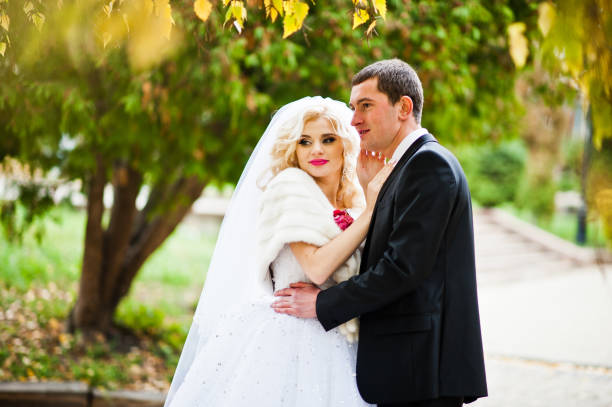 istock Charming wedding couple background golden leaves 653498524