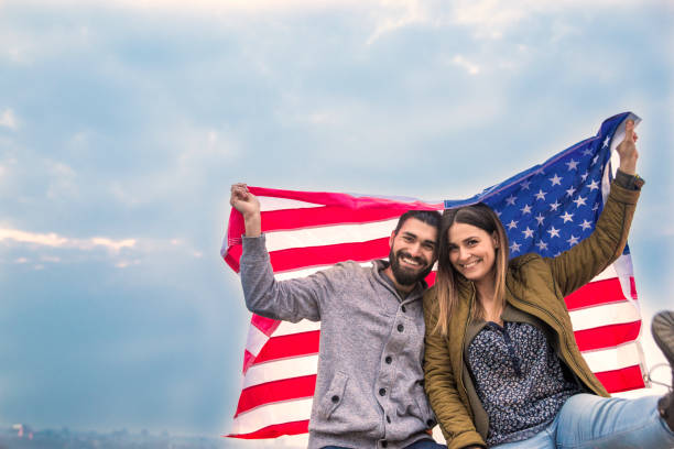 istock Happy couple holding an American flag 653498634