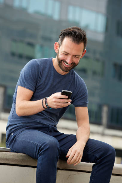 istock Relaxed mature man reading text message on mobile phone 653506322
