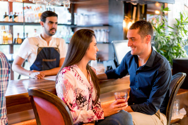 istock Happy couple drinking at the bar 653509776