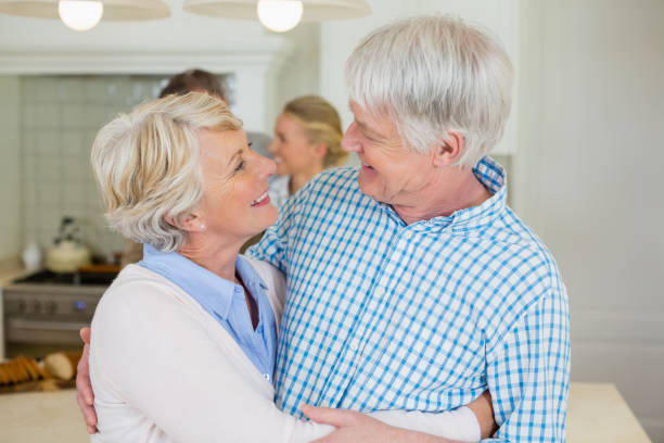 istock Romantic senior couple looking face to face in kitchen 653510500