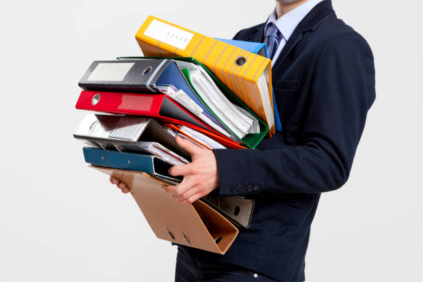 istock Business man carrying folders 653510816