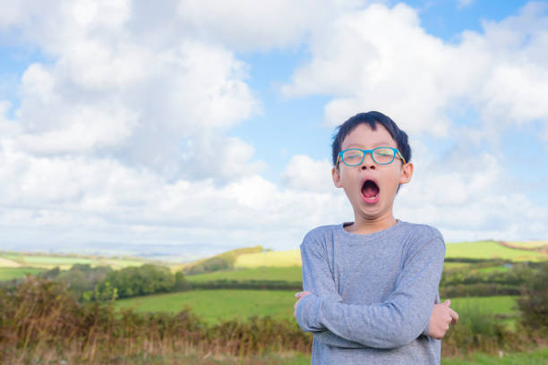 istock Young boy yawning outdoor 653510966