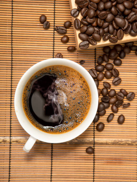 istock Coffee cup and beans on wooden,top view 653513824
