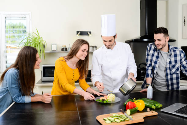istock professional personal chef cook in customer's private kitchen house giving a cooking lesson to young people at home 653517110