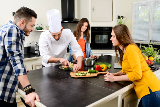 istock professional personal chef cook in customer's private kitchen house giving a cooking lesson to young people at home 653517148