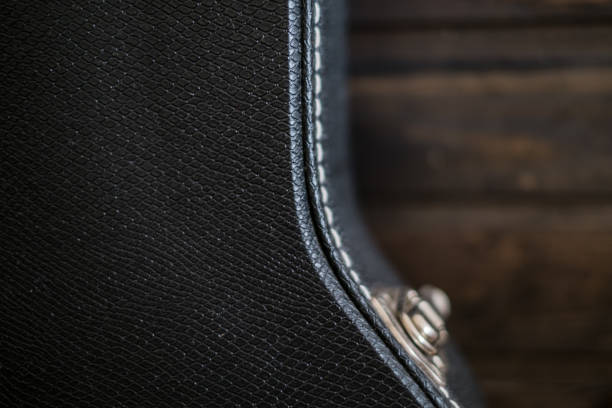 Black guitar case with wooden background