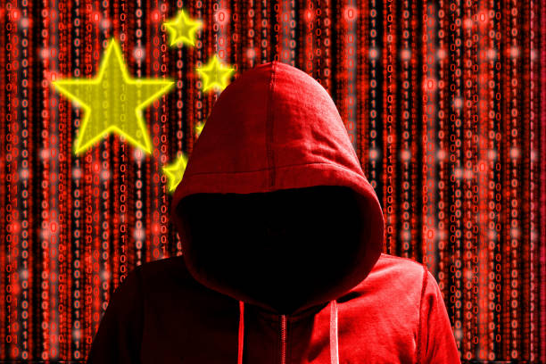 istock Chinese hacker in front of digital datastream flag 653518120