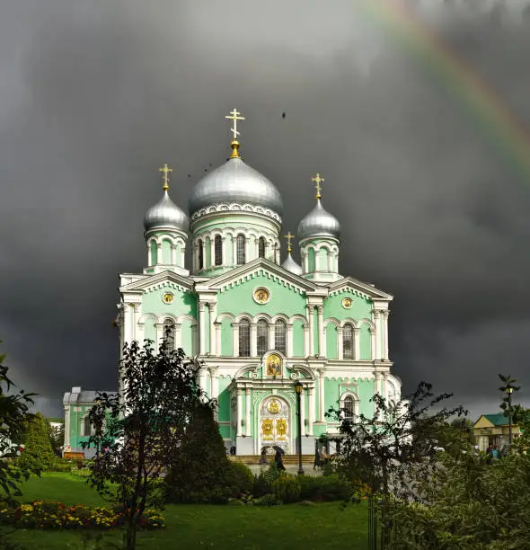 View of Trinity Cathedral in the Holy Trinity Seraphim-Diveevo monastery (Diveevo, Nizhny Novgorod region, Russia), domes and crosses of the Cathedral in a cloudy summer evening on a background of cloudy sky.
