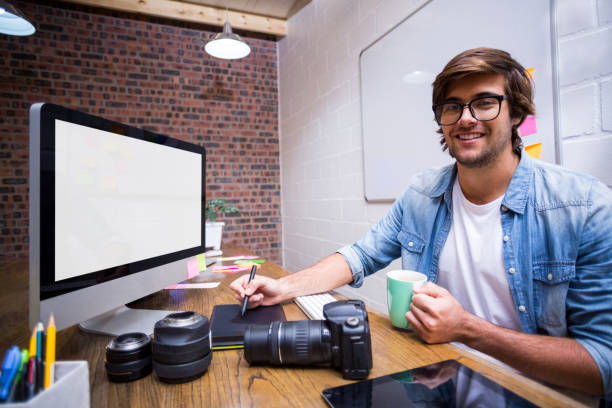 istock Portrait of smiling graphic designer working in office 653522816