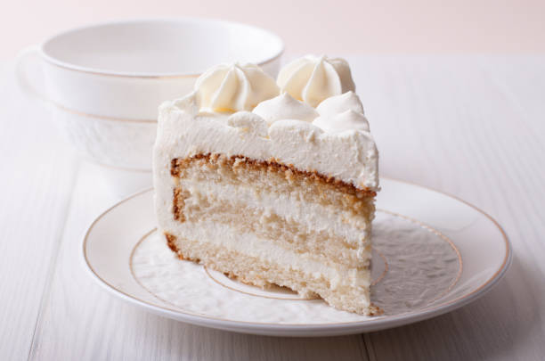 istock Biscuit cake with cream cheese cream on a white plate 653526082