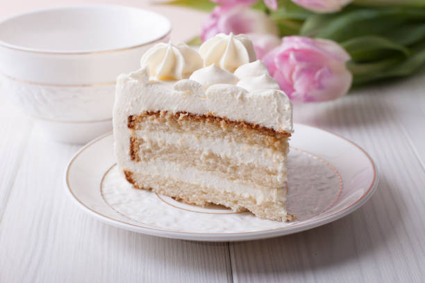 istock Biscuit cake with cream cheese cream on a white plate 653526238