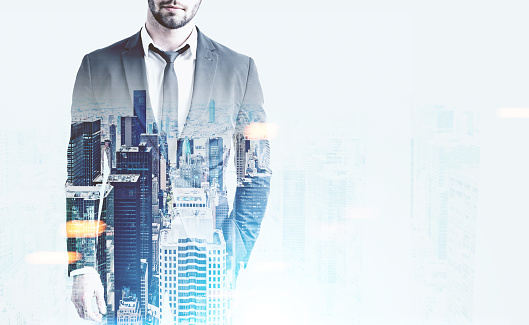 Front view of man in suit and tie on abstract city background with copy space. Skyscrapers in the background. Double exposure