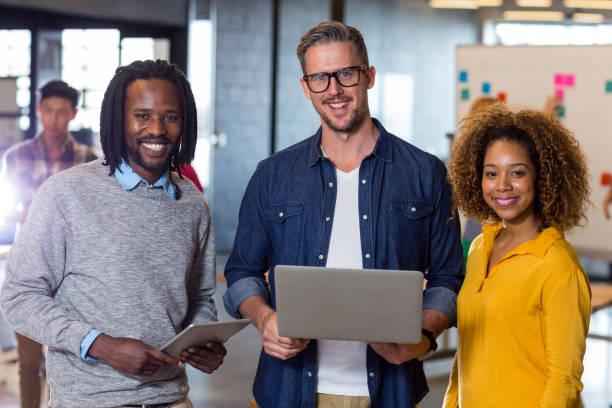 istock Portrait of colleagues standing in office 653528742