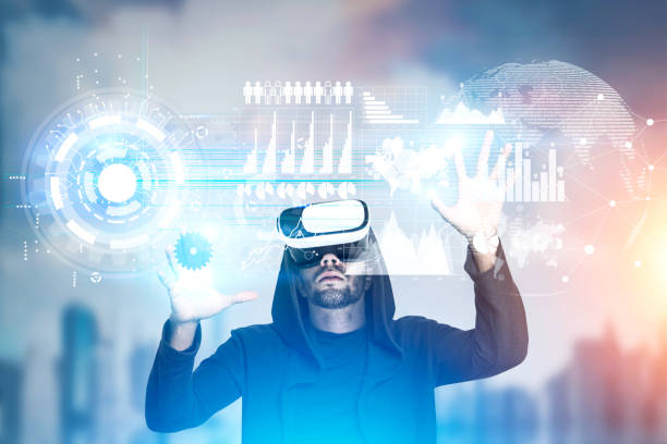 istock Man in vr glasses works with graphs in city, toned 653529496