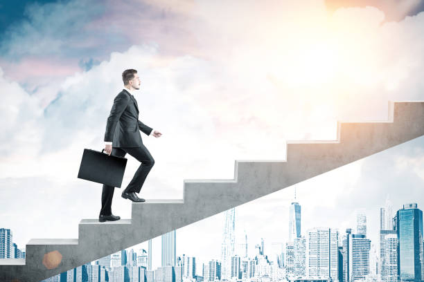 istock Man with suitcase climbing stairs in city 653532078